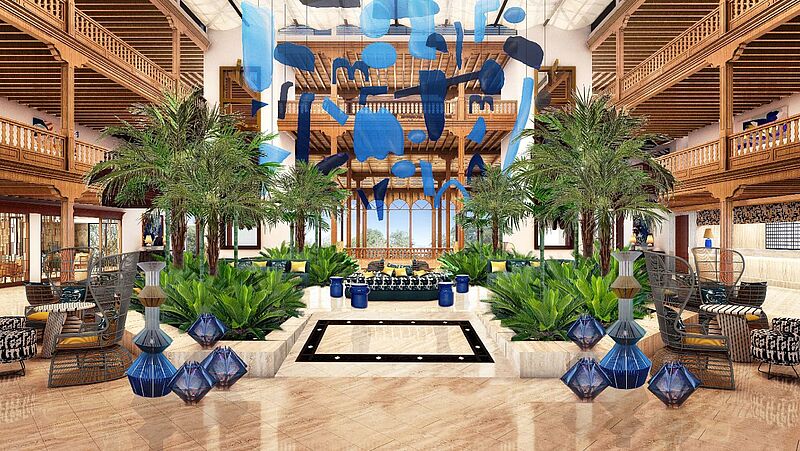 Elegante Hotellobby im Seaside Los Jameos, Lanzarote – stilvolles Interieur mit Palmen, moderner Kunst in Blau und gemütlichen Sitzbereichen im kanarischen Holzstil