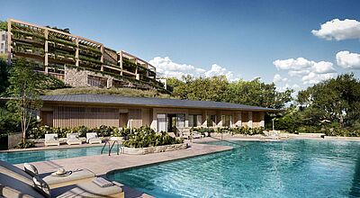 Ein mehrstöckiges Gebäude erhebt sich hinter einem Pool