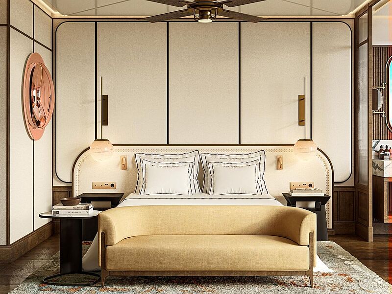 The Site Hotel Ibiza soll zur Saison 2026 eröffnen. Foto: Palladium Hotel Group Luxuriös eingerichtetes Hotelzimmer mit elegantem Doppelbett, moderner Innenarchitektur, warmen Holzelementen, Designerbeleuchtung und stilvoller Atmosphäre