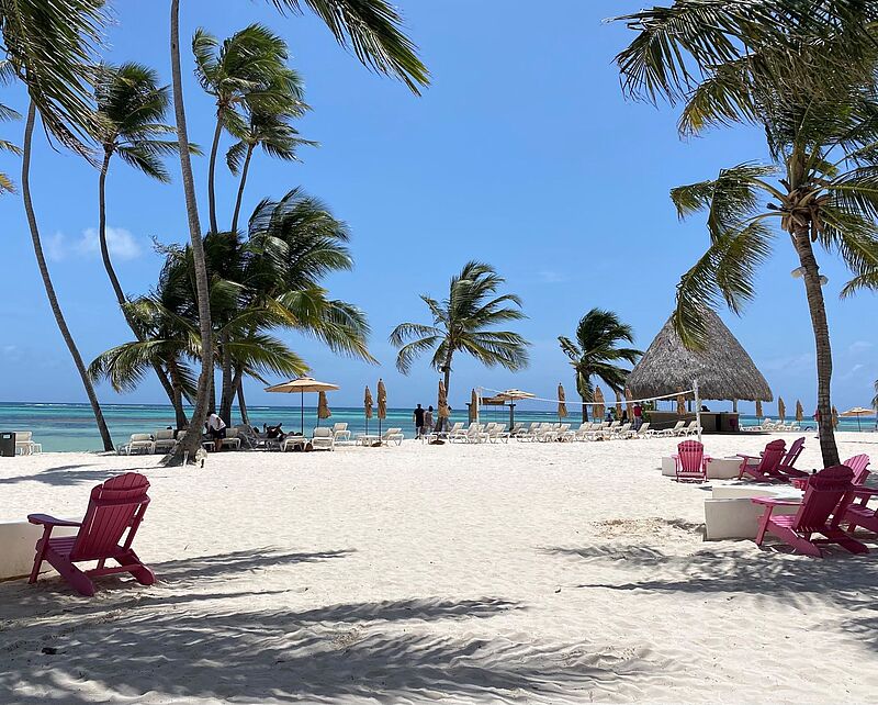 Ab Ende Oktober fliegt Discover Airlines auch von München nach Punta Cana Strandatmosphäre mit Liegestühlen und Palmen, im Hintergrund das Meer