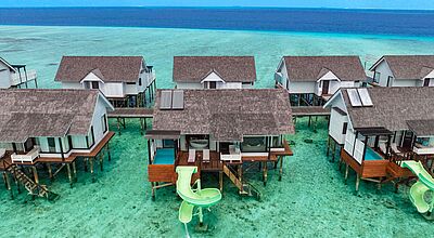 Luxuriöse Wasserbungalows mit privaten Pools und Rutschen über türkisblauem Meer auf den Malediven – exklusives tropisches Resort mit direktem Zugang zur Lagune.