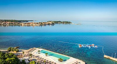 Vom Pical Resort kann man auf die Altstadt von Porec schauen Außenansicht des Valamar Collection Pical Resorts mit weißer Architektur, Poollandschaft und Meerblick an der kroatischen Küste.