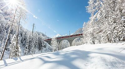 Der Bernina Express auf dem Albulaviadukt, verschneite Landschaft