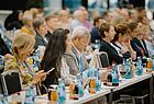 Blick in vollbesetzte Reihen eines Konferenzraums
