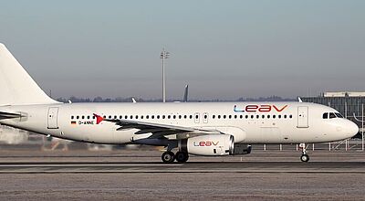 Weißer Airbus A320 der Fluggesellschaft Leav Aviation auf dem Rollfeld eines Flughafens bei Tageslicht. Die Registrierung D-ANNE kennzeichnet die deutsche Herkunft des Flugzeugs.