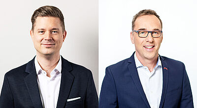 Zwei Männer in Business-Outfits nebeneinander in einem geteilten Bild. Der Mann auf der linken Seite hat kurze braune Haare, trägt einen dunklen Anzug mit einem weißen Hemd und hat einen dezenten Gesichtsausdruck. Der Mann auf der rechten Seite trägt eine Brille, hat kurze braune Haare mit grauen Strähnen, trägt einen dunkelblauen Anzug mit einem hellblauen Hemd und lächelt freundlich. Beide haben helle Haut und stehen vor neutralen Hintergründen