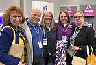 Vier Frauen und ein Mann am Stand von Bentour Reisen lächeln in die Kamera