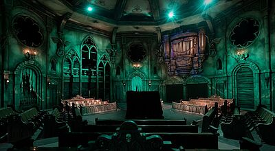 Die Besucher von Danse Macabre nehmen auf Chorbänken in einer düsteren Abtei Platz