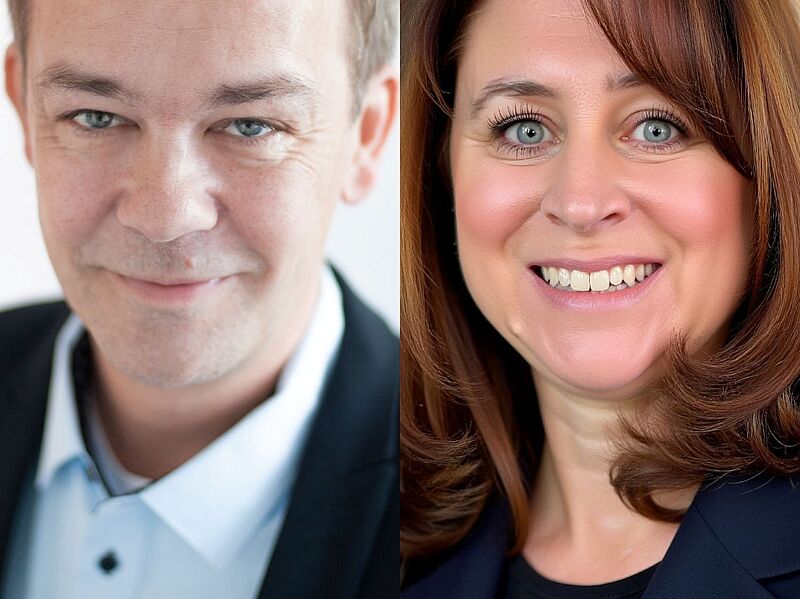 Zwei Porträtfotos nebeneinander: links ein lächelnder Mann mit kurzem Haar und hellem Hemd unter einem  dunklen Sakko, rechts eine lächelnde Frau mit schulterlangem braunem Haar und dunklem Blazer. Beide blicken direkt in die Kamera.
