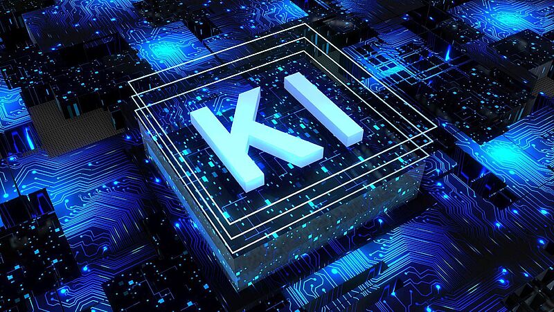Dreidimensionale Darstellung eines Computerchips mit leuchtenden blauen Leiterbahnen. In der Mitte des Chips steht in großen Buchstaben „KI“, was für Künstliche Intelligenz steht. Das Bild symbolisiert moderne Technologie, Digitalisierung und Datenverarbeitung.