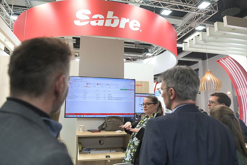 Menschen an einem Messestand auf der ITB in Berlin