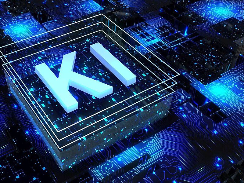 Digitales Konzeptbild mit dem Schriftzug „KI“ (für Künstliche Intelligenz) in leuchtenden, dreidimensionalen Buchstaben auf einem stilisierten Mikrochip-Hintergrund. Die Umgebung ist von blauen Leiterbahnen, Datenpunkten und leuchtenden Schaltkreisen geprägt, was eine Hightech-Atmosphäre vermittelt.