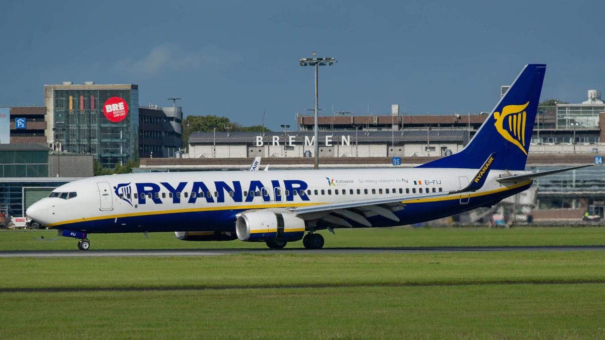 Ein Passagierflugzeug der Fluggesellschaft Ryanair rollt auf dem Rollfeld des Flughafens Bremen vor dem Terminalgebäude bei klarem, sonnigem Tageslicht.